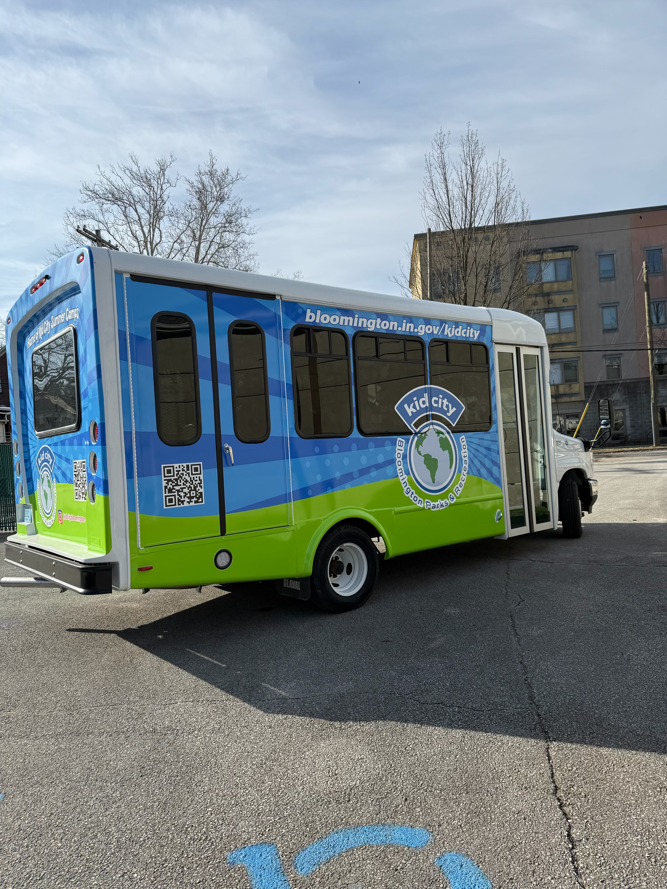 Kid City mini bus in a parking lot, showing the accessible entry doors